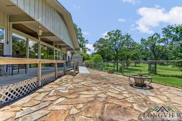 620 Shadywood Ln, Avinger, TX 75630 - view of patio featuring a fire pit, a wooden deck, and a storage unit