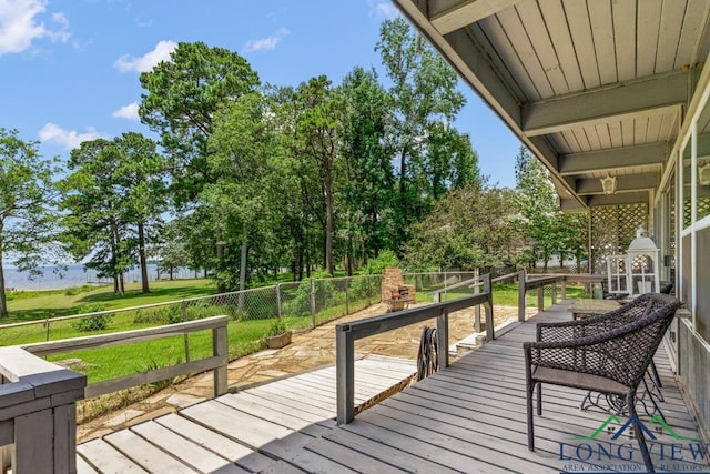 620 Shadywood Ln, Avinger, TX 75630 - wooden terrace with a water view, a fenced backyard, and view of wooded area