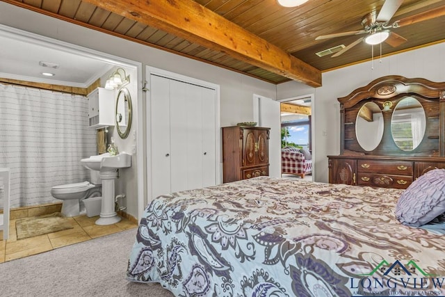 620 Shadywood Ln, Avinger, TX 75630 - carpeted bedroom with wooden ceiling, ensuite bathroom, a closet, tile patterned flooring, and ceiling fan