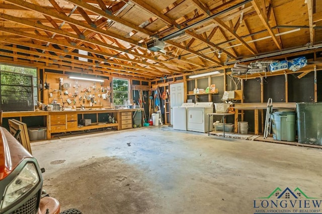 620 Shadywood Ln, Avinger, TX 75630 - garage featuring a workshop area, separate washer and dryer, and a garage door opener