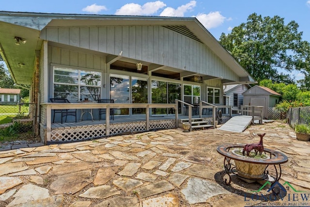 620 Shadywood Ln, Avinger, TX 75630 - rear view of property featuring an outdoor fire pit, a deck, a shed, and a patio