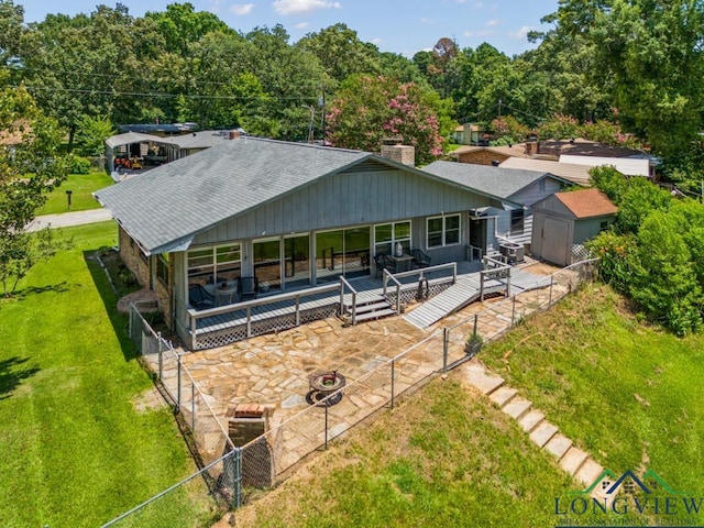 620 Shadywood Ln, Avinger, TX 75630 - back of house featuring a storage shed, a deck, roof with shingles, and a chimney