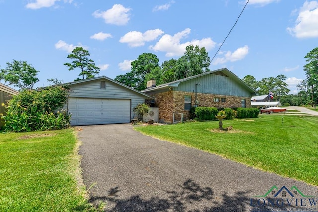 620 Shadywood Ln, Avinger, TX 75630 - ranch-style home featuring brick siding, a front yard, asphalt driveway, and a chimney