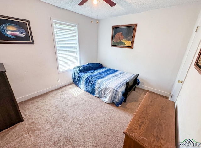 110 Mockingbird Ln, Linden, TX 75563 - carpeted bedroom featuring a textured ceiling and a ceiling fan