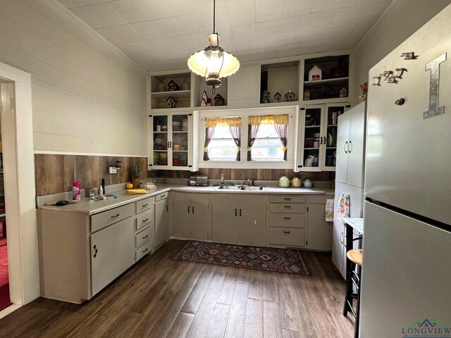 123 E 12th St, Mount Pleasant, TX 75455 - kitchen featuring freestanding refrigerator, open shelves, a sink, light countertops, and dark wood-style floors