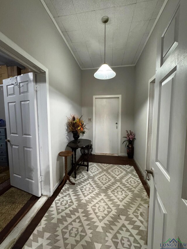 123 E 12th St, Mount Pleasant, TX 75455 - doorway featuring ornamental molding, wood finished floors, and baseboards