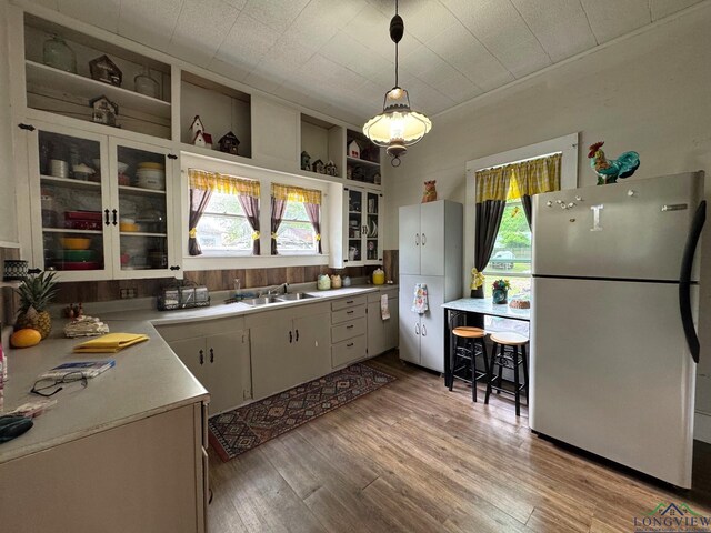 123 E 12th St, Mount Pleasant, TX 75455 - kitchen with freestanding refrigerator, a sink, plenty of natural light, and light countertops