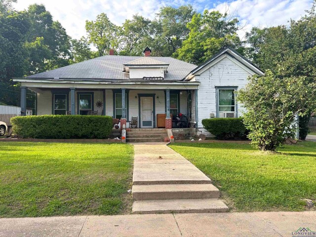 123 E 12th St, Mount Pleasant, TX 75455 - bungalow-style house with a porch, a front lawn, and a chimney