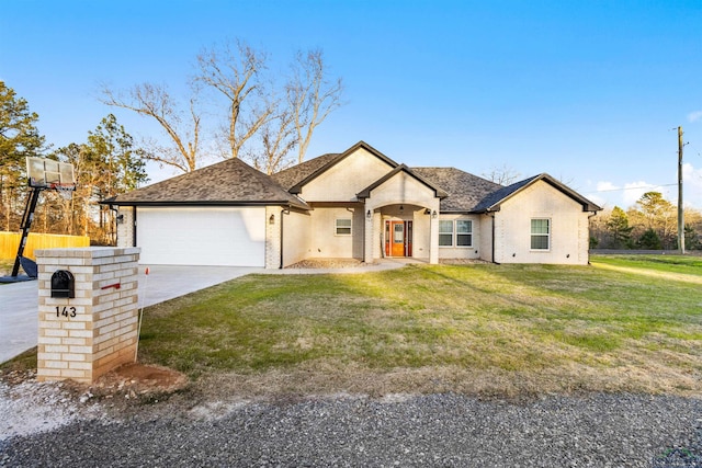 view of front of home featuring a garage and a front lawn