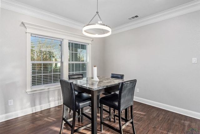 dining space featuring dark hardwood / wood-style flooring and crown molding