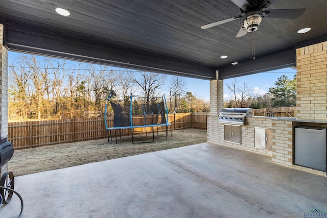 view of patio / terrace with a trampoline, area for grilling, ceiling fan, and a grill