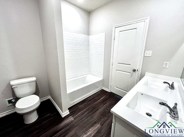 bathroom featuring vanity, hardwood / wood-style flooring, and toilet