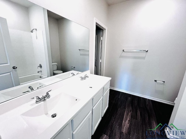 full bathroom featuring shower / bathing tub combination, vanity, hardwood / wood-style flooring, and toilet