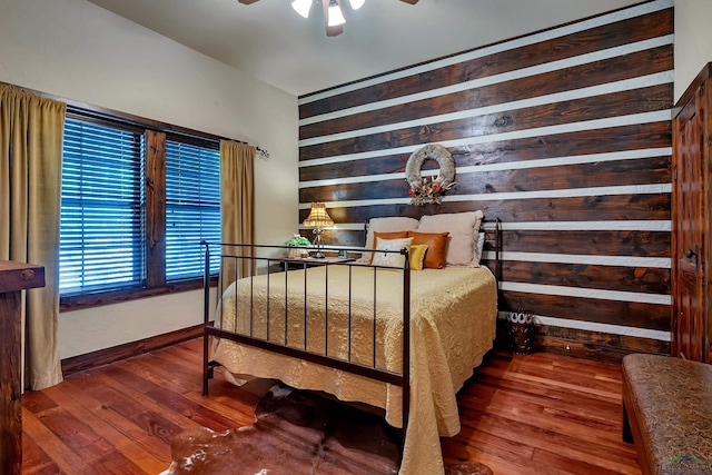1355 Snapdragon Rd, Diana, TX 75640 - bedroom featuring wood walls, baseboards, and hardwood / wood-style floors