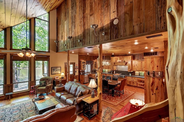 1355 Snapdragon Rd, Diana, TX 75640 - living room with visible vents, hardwood / wood-style floors, a towering ceiling, and a healthy amount of sunlight