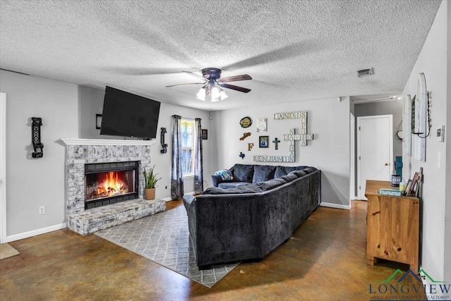 living room with ceiling fan and a textured ceiling