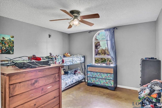 bedroom with ceiling fan and a textured ceiling