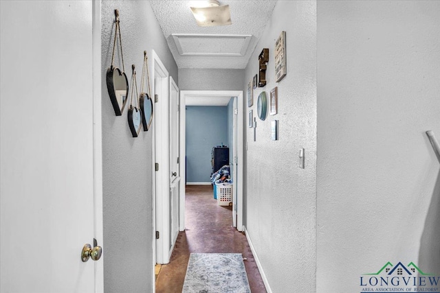 hallway with a textured ceiling