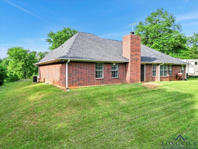 back of property featuring a lawn