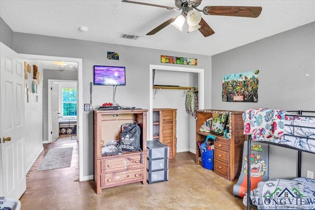 bedroom with a textured ceiling and ceiling fan