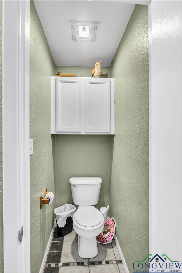 bathroom featuring tile patterned flooring and toilet