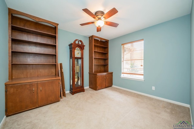 unfurnished living room with ceiling fan and light colored carpet