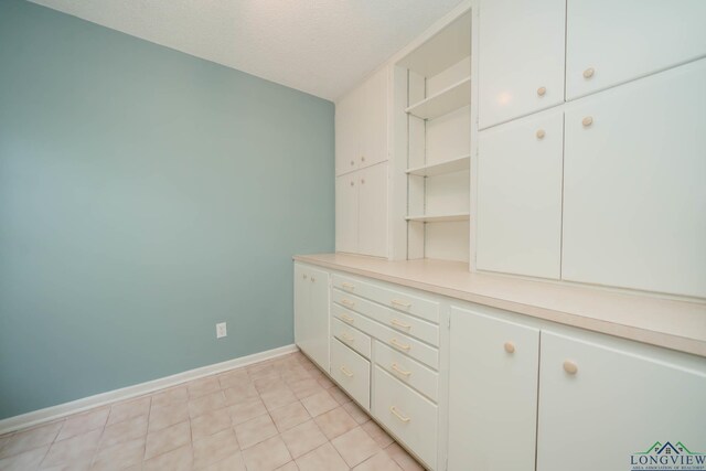 walk in closet featuring light tile patterned flooring