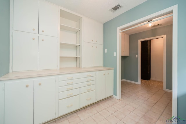 interior space with light tile patterned floors