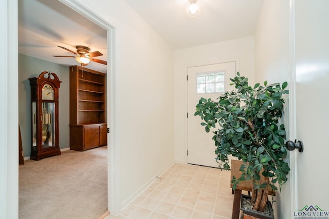 carpeted entryway with ceiling fan