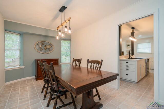 tiled dining space featuring sink and ornamental molding