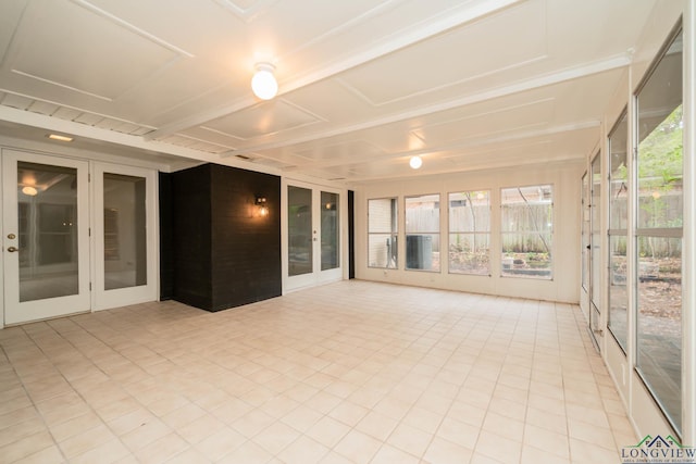 unfurnished sunroom with french doors