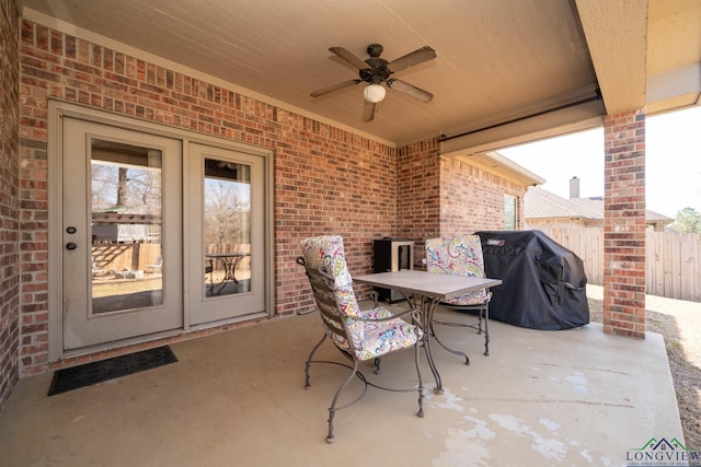 view of patio / terrace with a ceiling fan, outdoor dining space, a grill, and fence