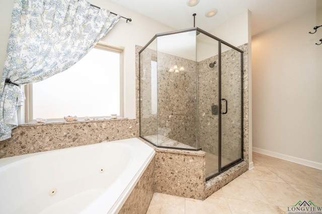 bathroom with a tub with jets, tile patterned flooring, a shower stall, and baseboards