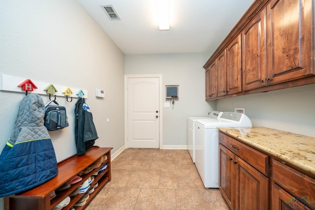 clothes washing area featuring light tile patterned floors, visible vents, baseboards, independent washer and dryer, and cabinet space