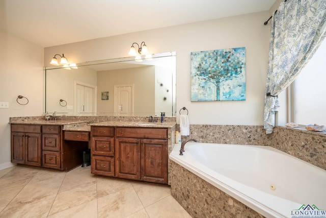 bathroom featuring double vanity, tile patterned flooring, a sink, and a bath