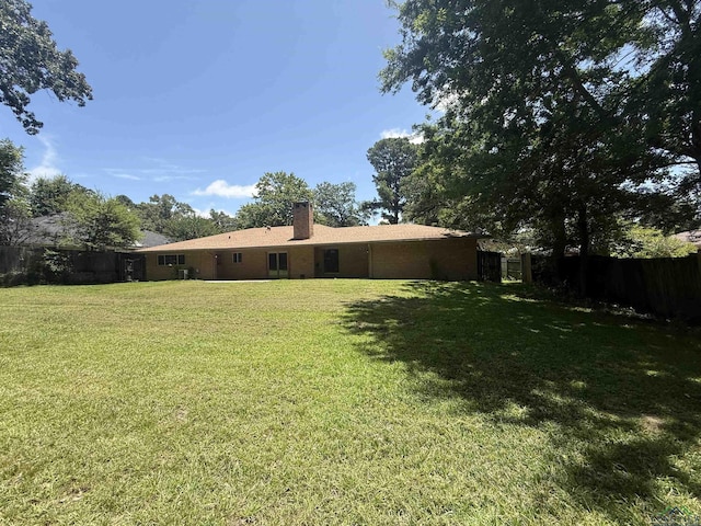 1705 Hyacinth Dr, Longview, TX 75601 - rear view of property featuring a chimney and a garage