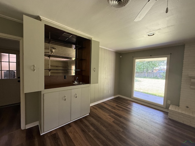 1705 Hyacinth Dr, Longview, TX 75601 - unfurnished dining area featuring crown molding and dark wood-style floors