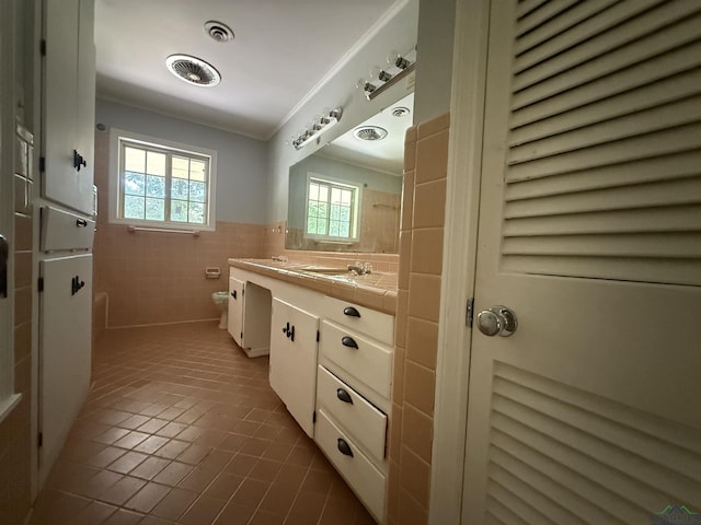 1705 Hyacinth Dr, Longview, TX 75601 - bathroom with vanity, tile patterned flooring, tile walls, wainscoting, and ornamental molding