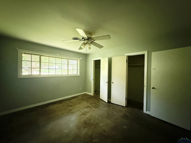1705 Hyacinth Dr, Longview, TX 75601 - unfurnished bedroom with multiple closets, concrete floors, and ceiling fan