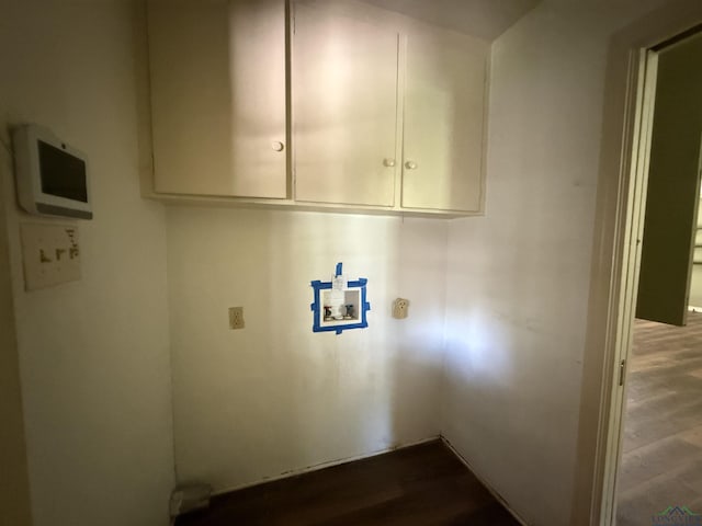 1705 Hyacinth Dr, Longview, TX 75601 - laundry area with washer hookup, cabinet space, and wood finished floors