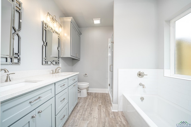 full bathroom featuring hardwood / wood-style flooring, vanity, toilet, and plus walk in shower