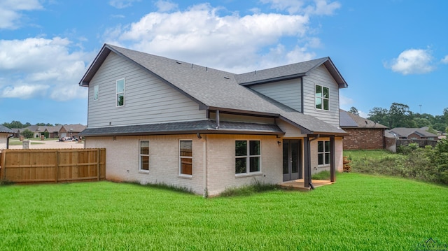 rear view of property with a lawn