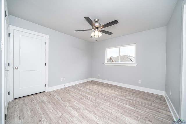 unfurnished room with ceiling fan and light wood-type flooring