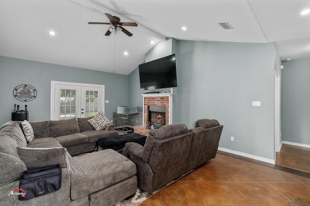 living room featuring french doors, tile patterned floors, lofted ceiling with beams, ceiling fan, and a fireplace