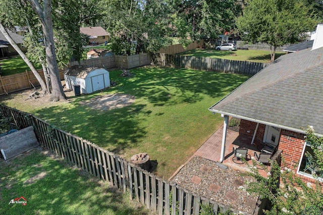 view of yard with a storage unit and a patio area