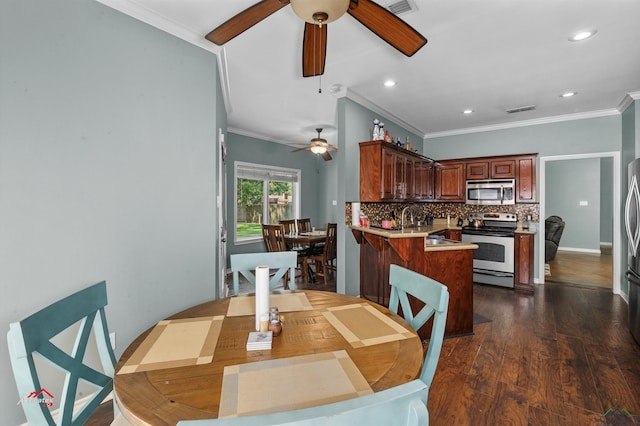 dining space featuring crown molding, dark hardwood / wood-style flooring, and ceiling fan