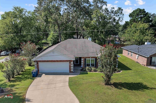 view of front of house with a front yard and a garage