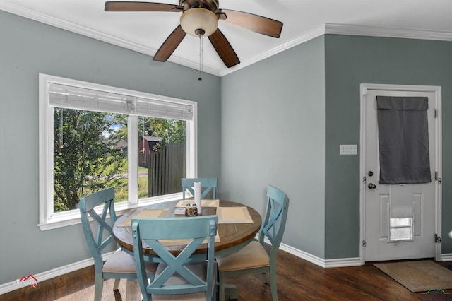 dining room with dark hardwood / wood-style flooring, ceiling fan, and crown molding