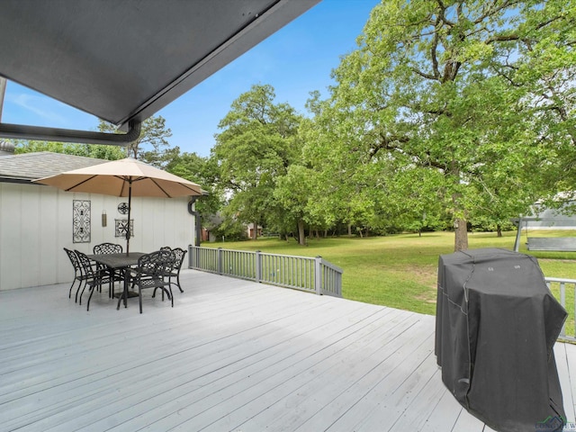 wooden terrace with a lawn, outdoor dining area, and area for grilling
