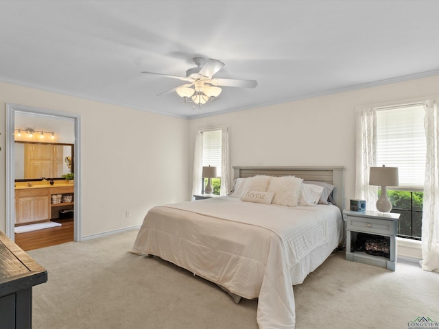 bedroom with light colored carpet, ornamental molding, and multiple windows